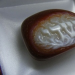 Agate. size 3.5 x 2.7 cm Amulet.
Hight relief carved on agate with using
light color for image and red-brown
background .